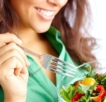 Healthy plate of vegetables and fruits to support good oral health.