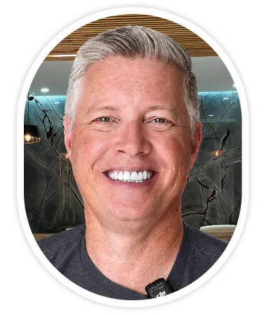 Smiling male patient showing his All-on-4 dental treatment.